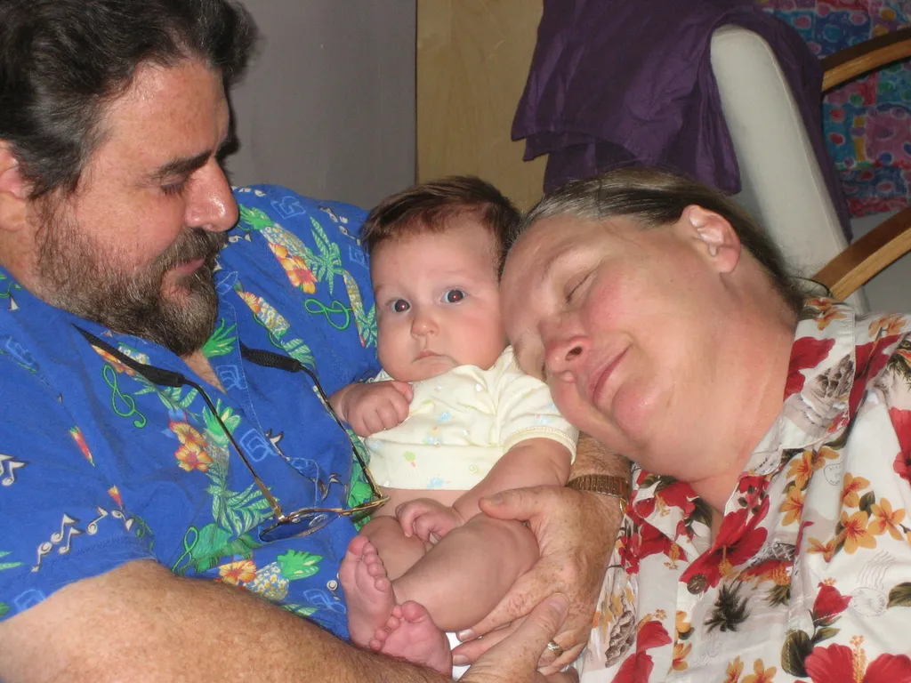 happy grandparents; worried baby