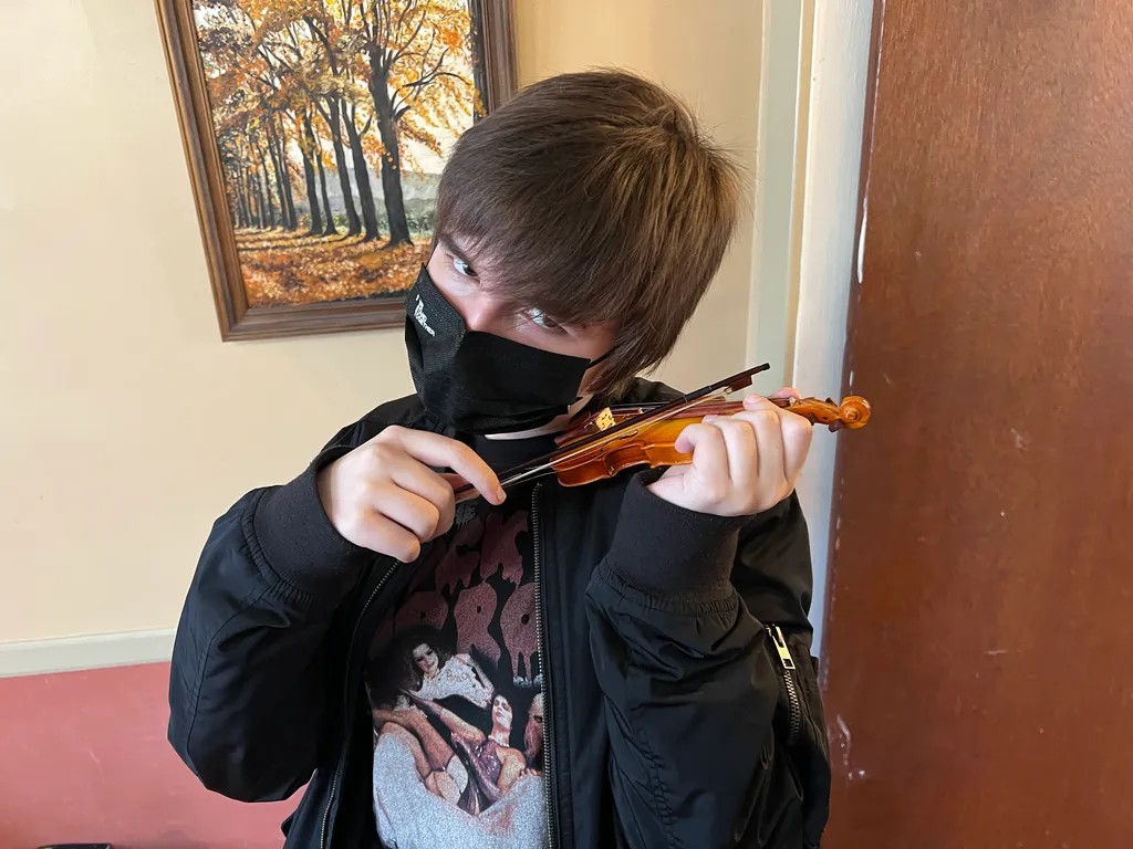 Marty plays a small violin