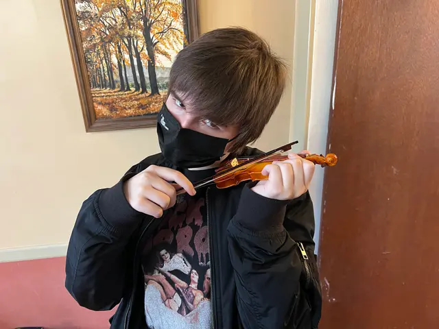 Marty plays a small violin
